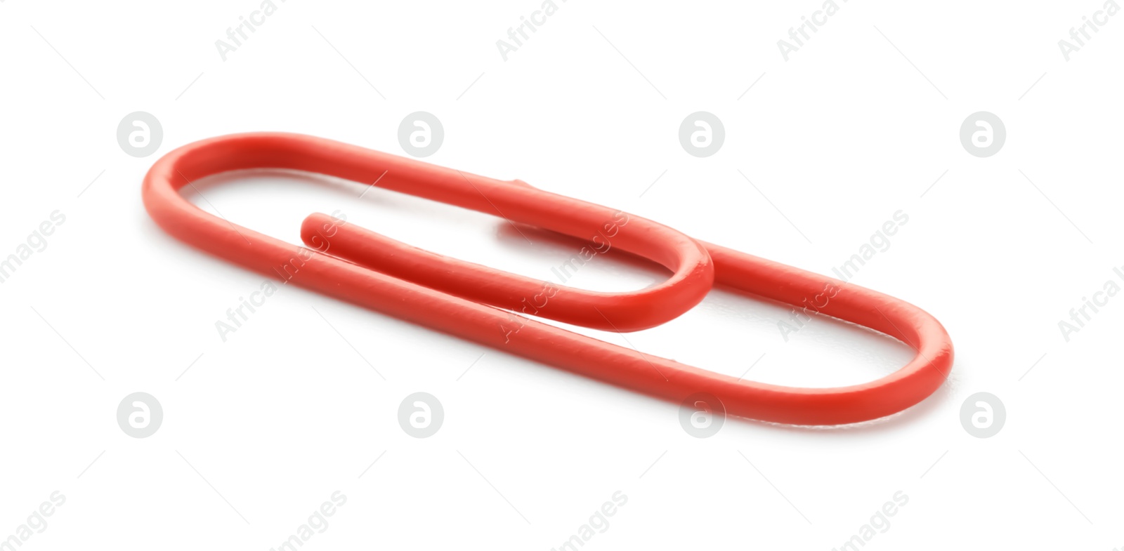 Photo of One bright paper clip isolated on white