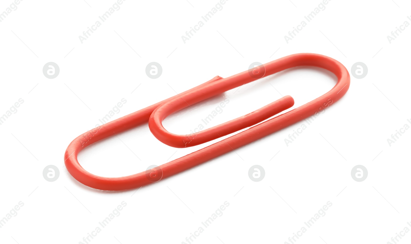 Photo of One bright paper clip isolated on white