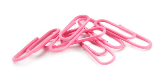 Photo of Many pink paper clips isolated on white