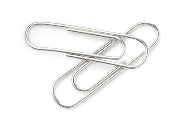 Photo of Two metal paper clips isolated on white, top view