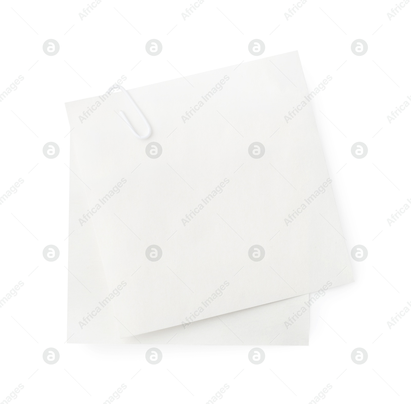 Photo of Blank paper note attached with clip isolated on white, top view