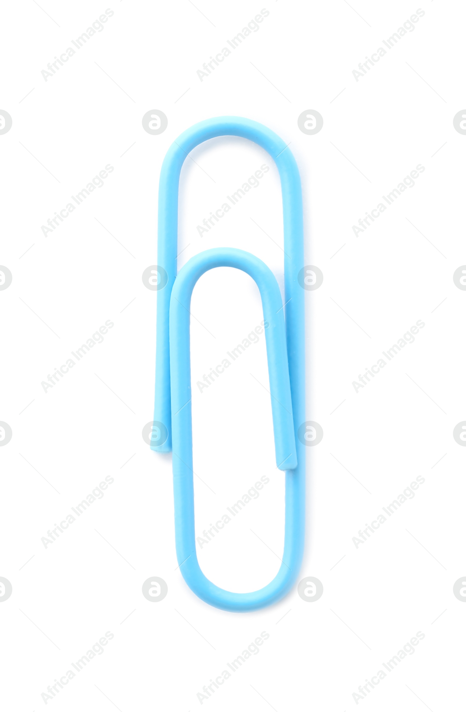 Photo of One bright paper clip isolated on white, top view