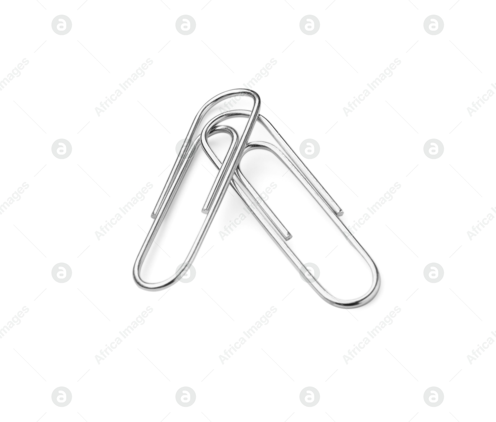 Photo of Metal paper clips isolated on white. Office stationery