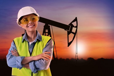 Worker at oil production site with crude oil pump