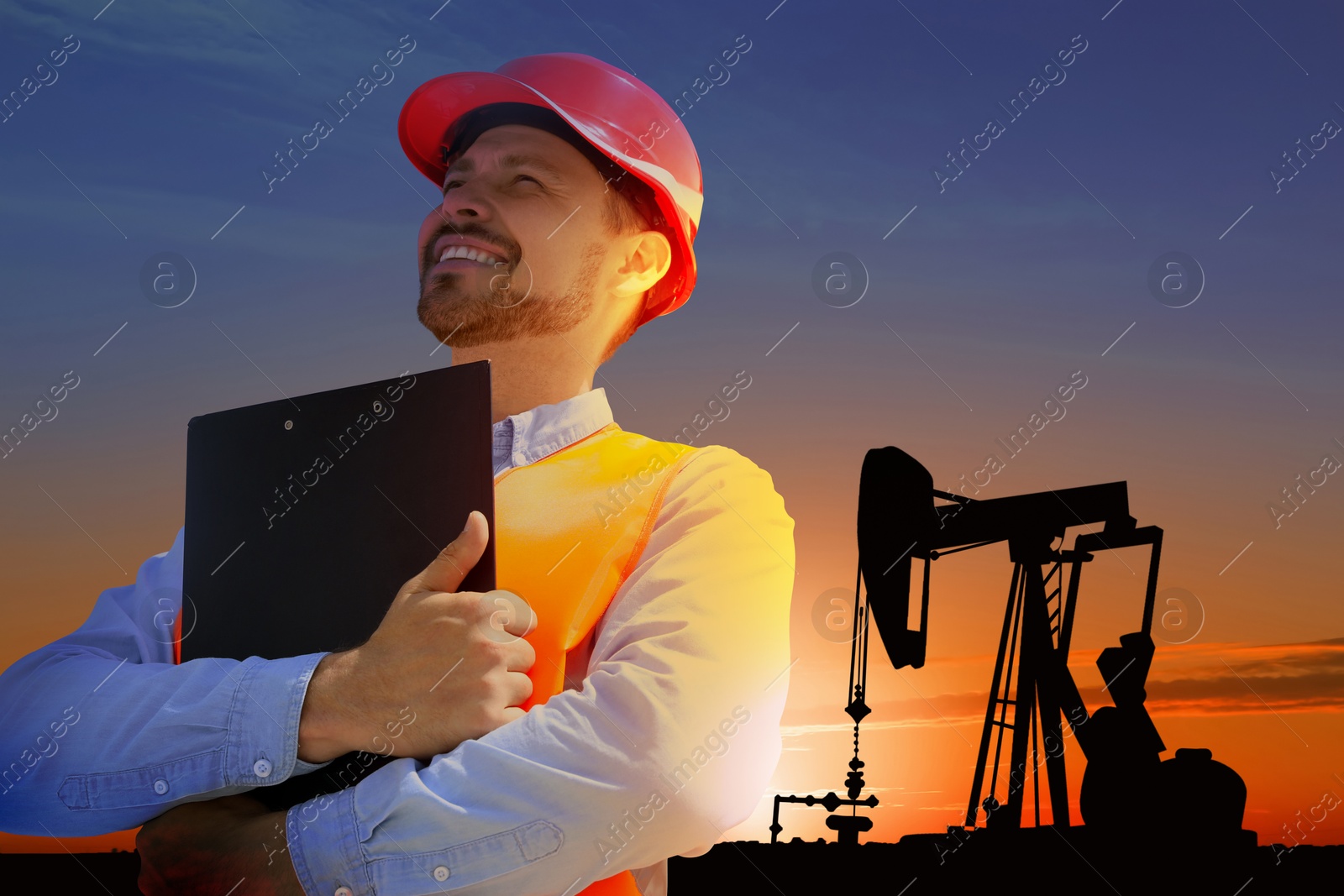 Image of Worker at oil production site with crude oil pump