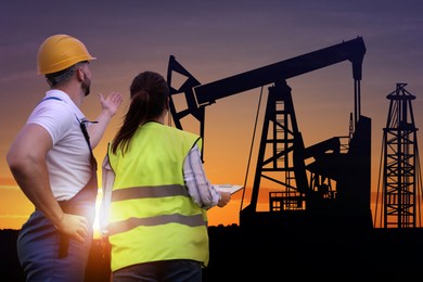 Workers at oil production site with crude oil pump