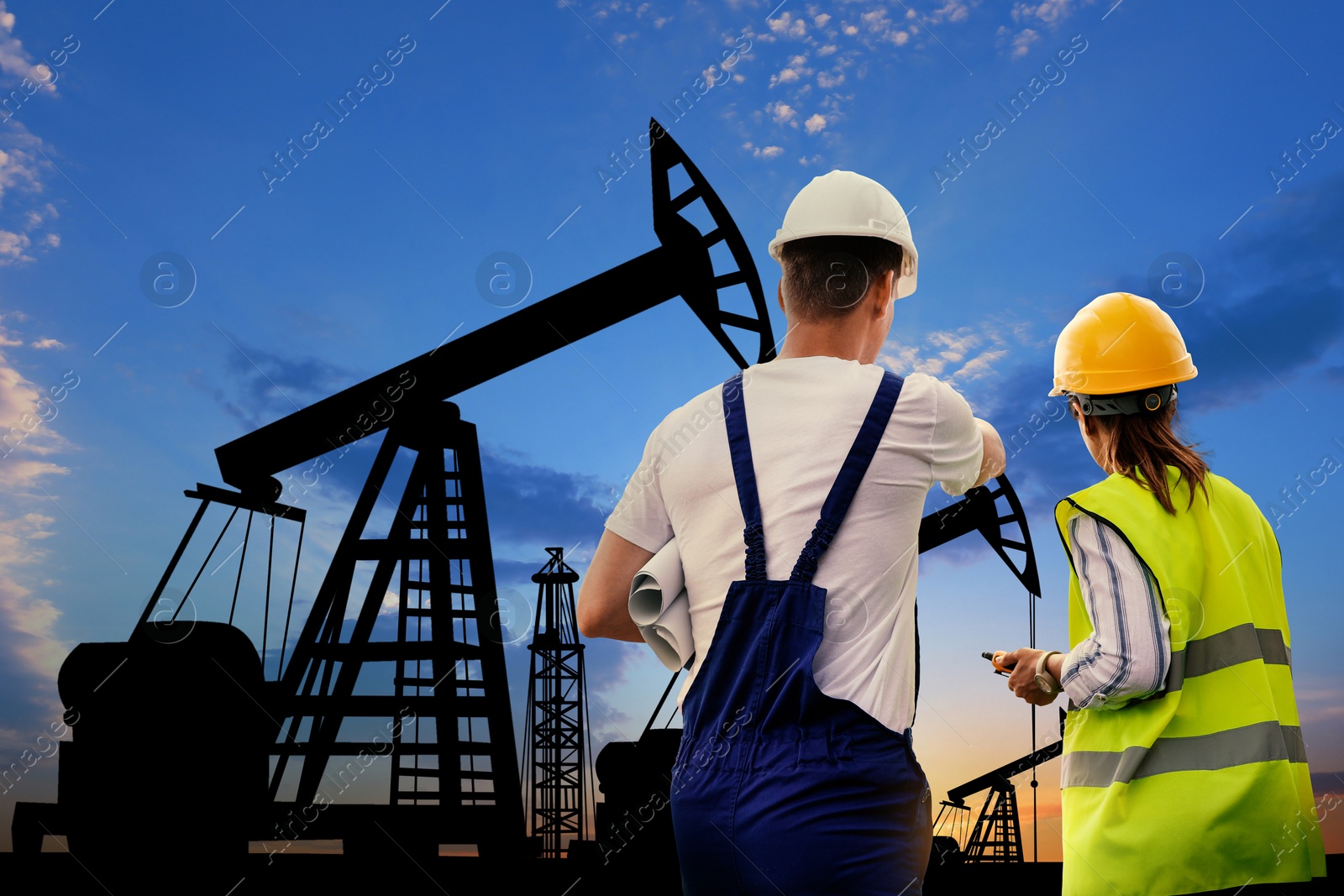 Image of Workers at oil production site with crude oil pumps