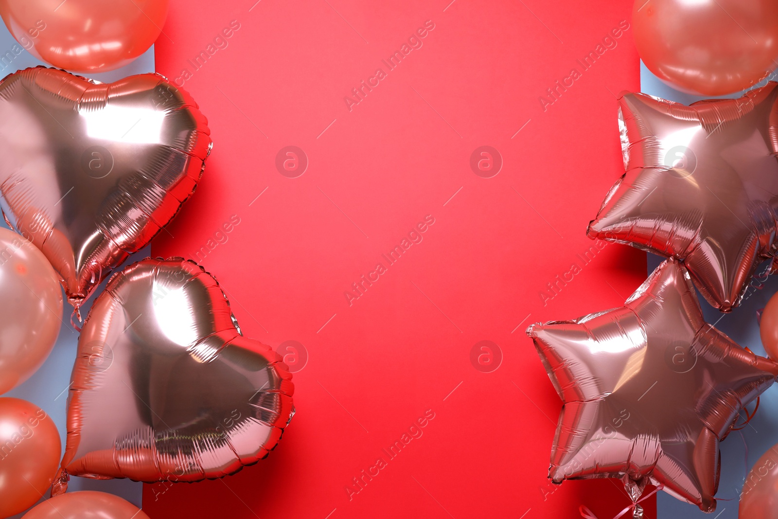 Photo of Colorful balloons on red background, flat lay. Space for text