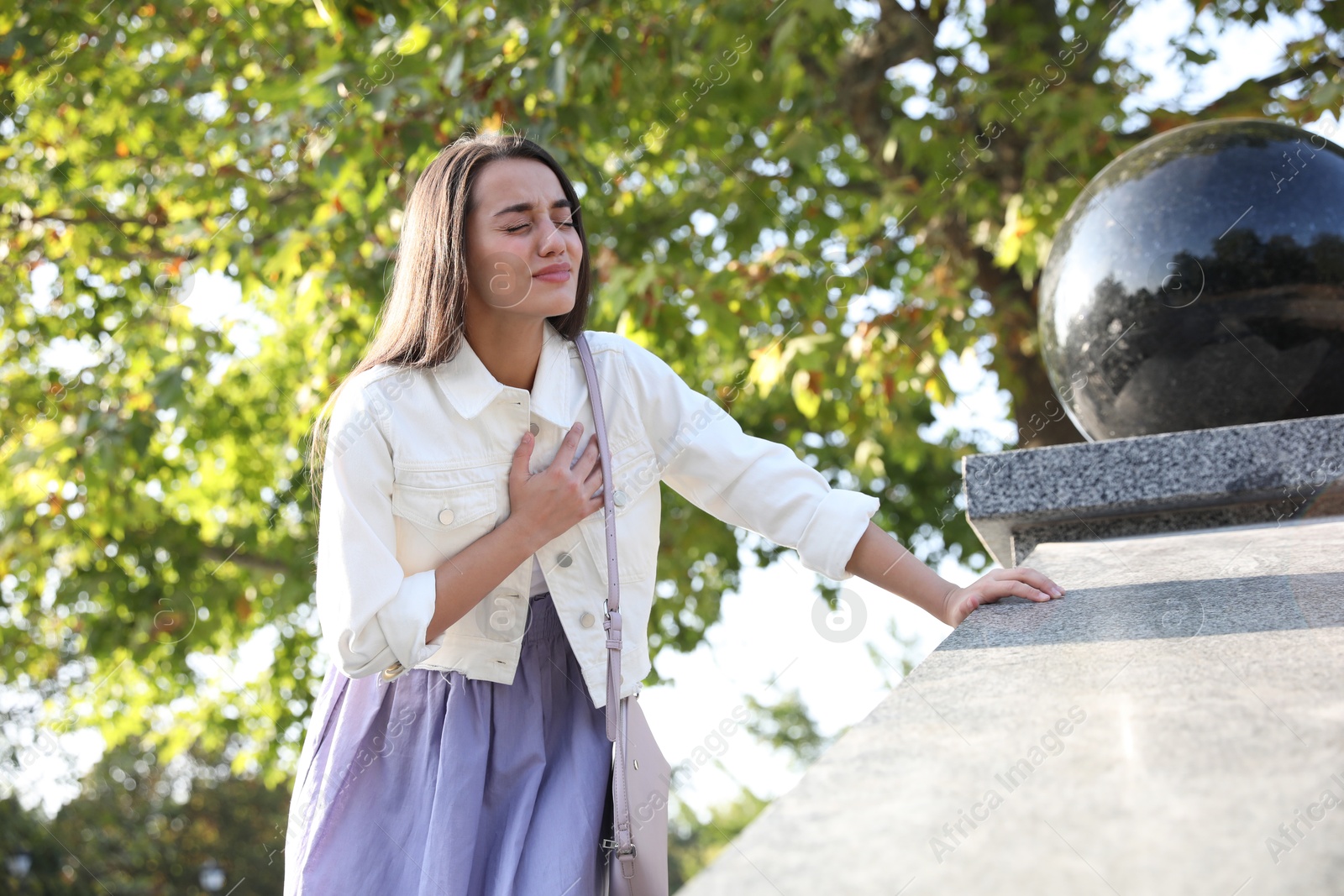 Photo of Young woman having heart attack in park