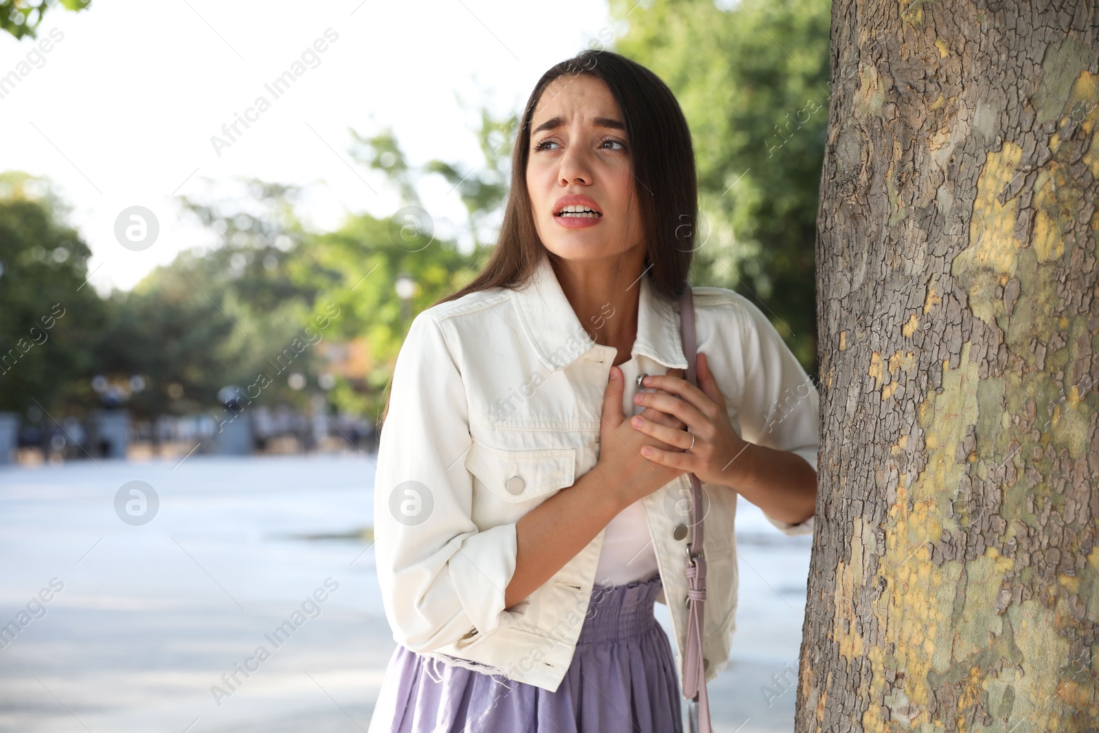 Photo of Young woman having heart attack in park