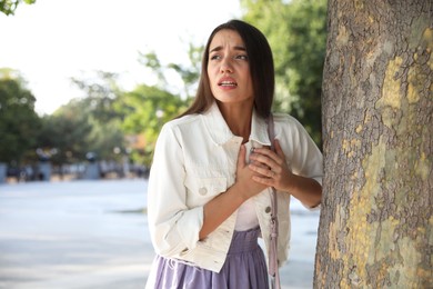 Photo of Young woman having heart attack in park