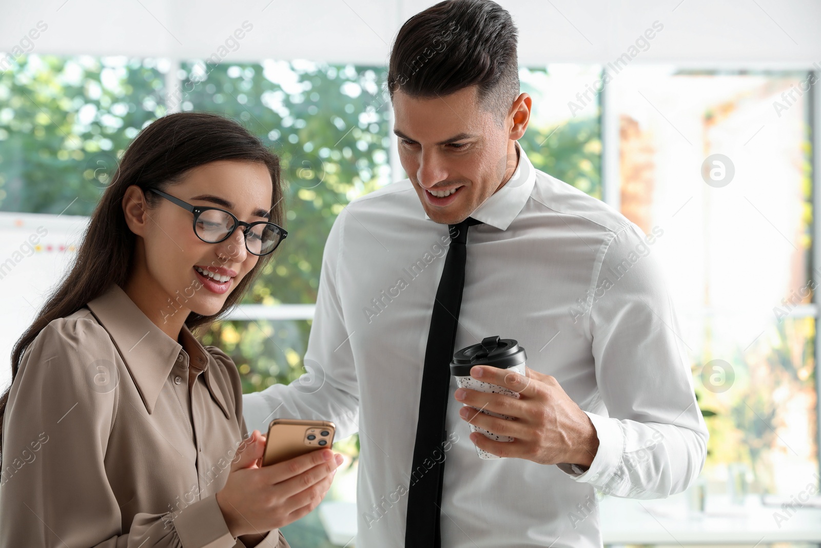 Photo of Office employees talking at workplace during break