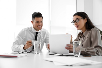 Photo of Office employees talking at table during meeting