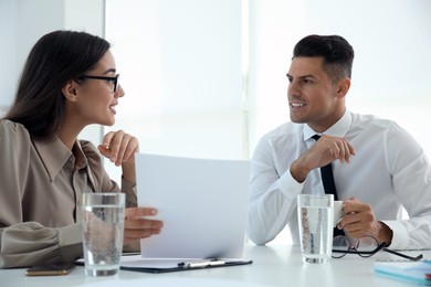 Photo of Office employees talking at table during meeting