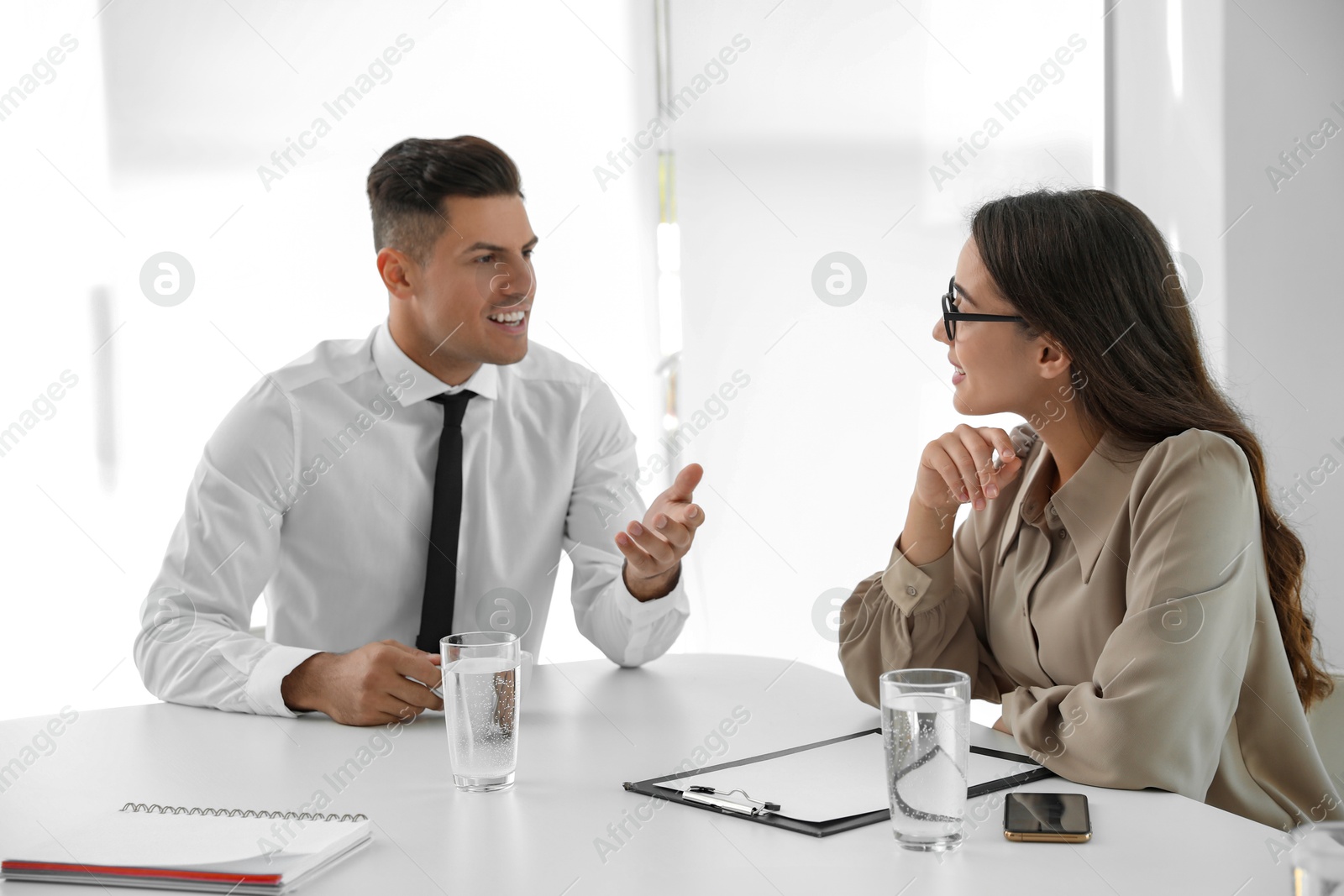 Photo of Office employees talking at table during meeting