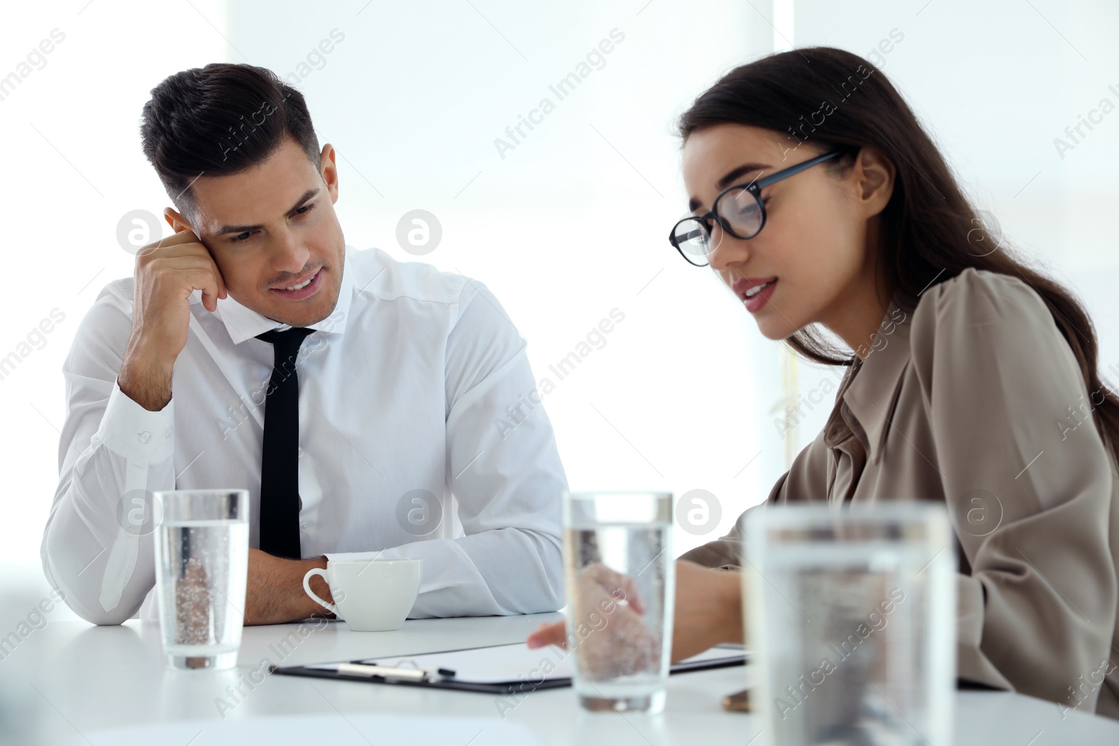 Photo of Office employees talking at table during meeting