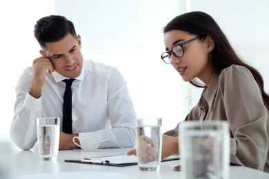 Photo of Office employees talking at table during meeting