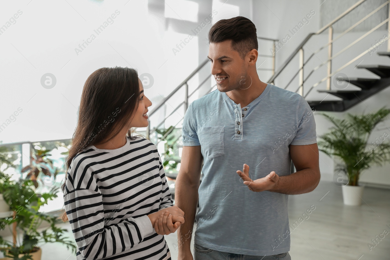 Photo of Man and woman having conversation in hall