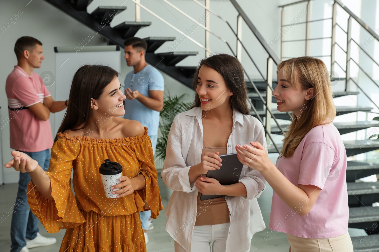 Photo of Group of women having conversation in hall