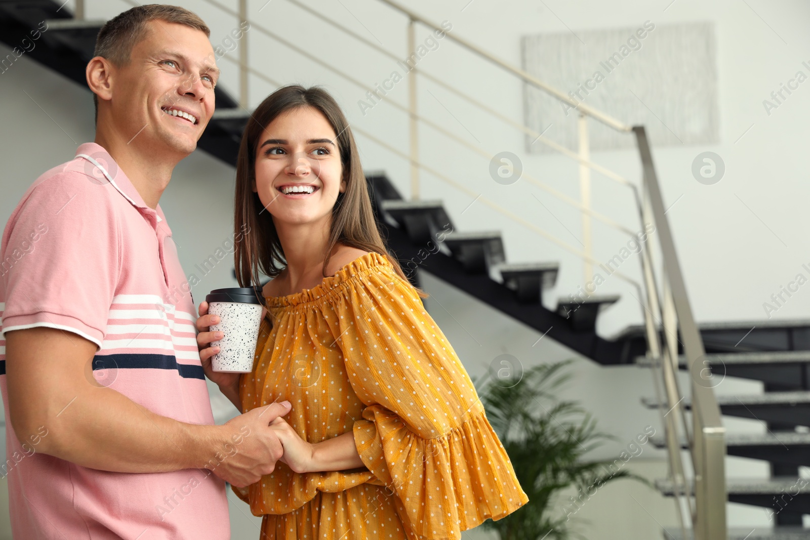 Photo of Man and woman having conversation in hall