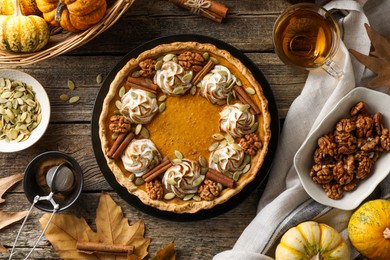 Photo of Flat lay composition with homemade pumpkin pie on wooden table