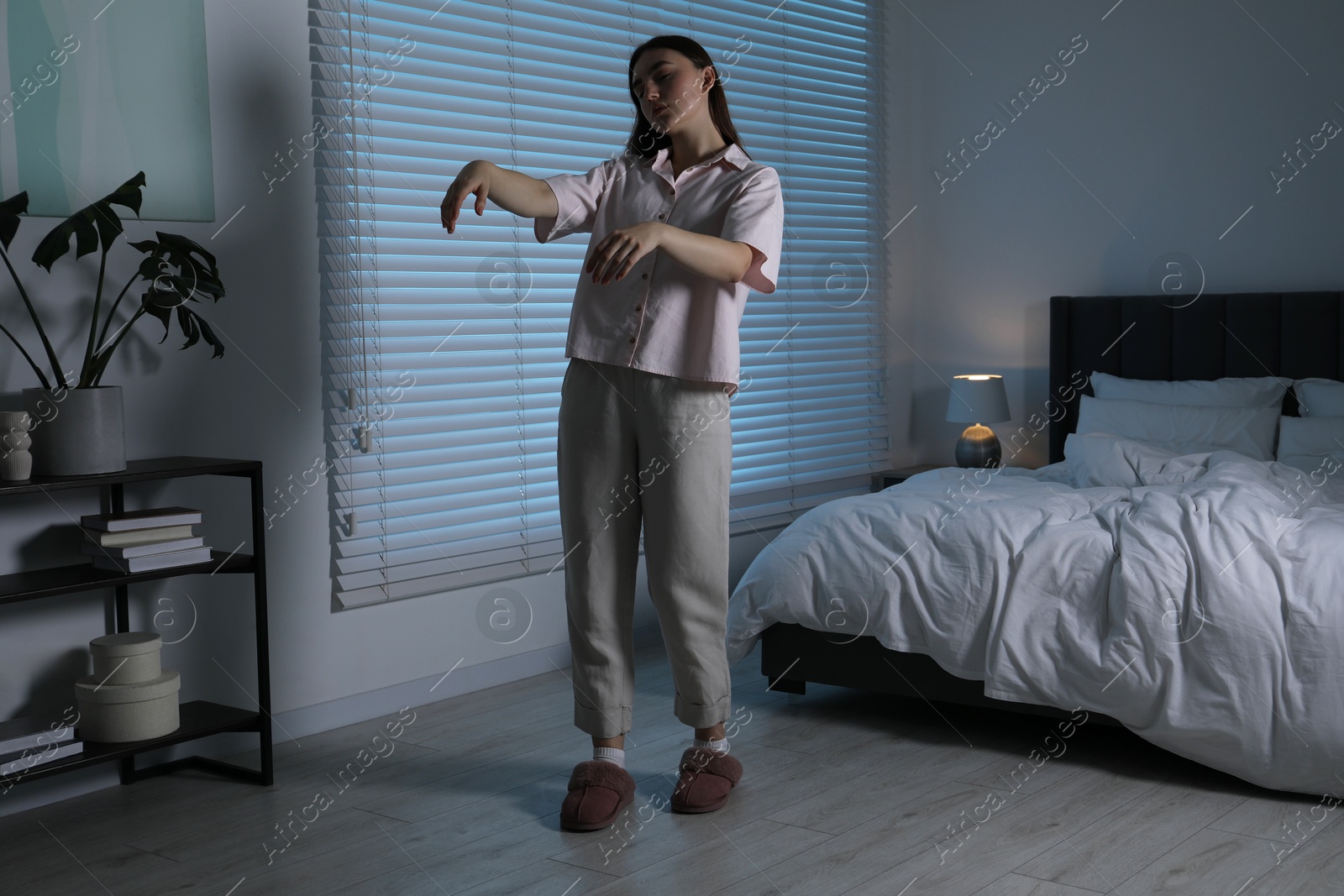 Photo of Young woman suffering from sleepwalking at home