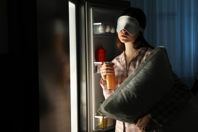 Photo of Young woman suffering from sleepwalking near fridge at home