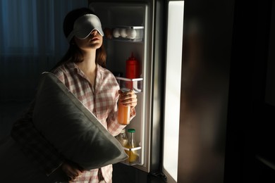 Photo of Young woman suffering from sleepwalking near fridge at home