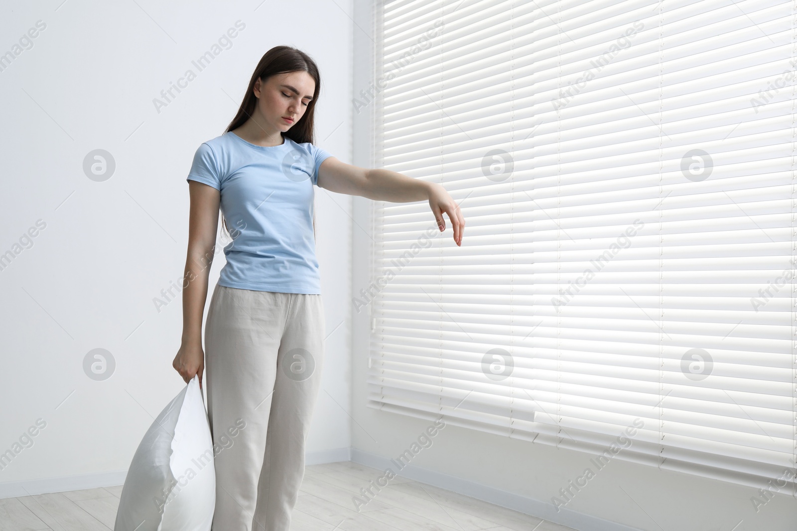 Photo of Young woman suffering from sleepwalking at home, space for text