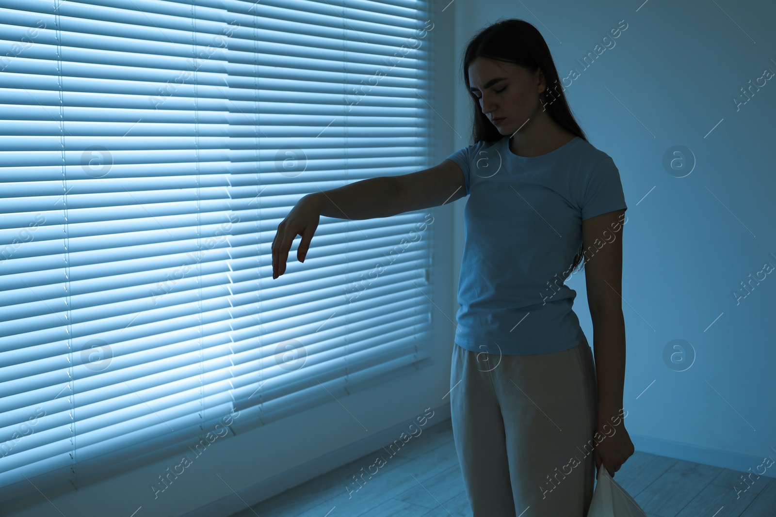 Photo of Young woman suffering from sleepwalking at home, space for text