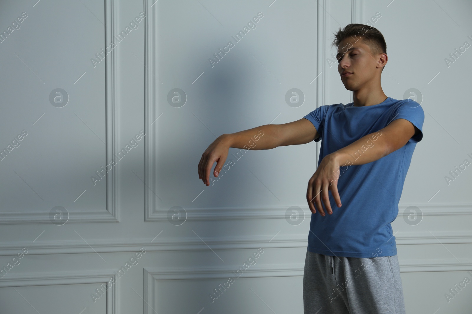 Photo of Young man suffering from sleepwalking at home, space for text