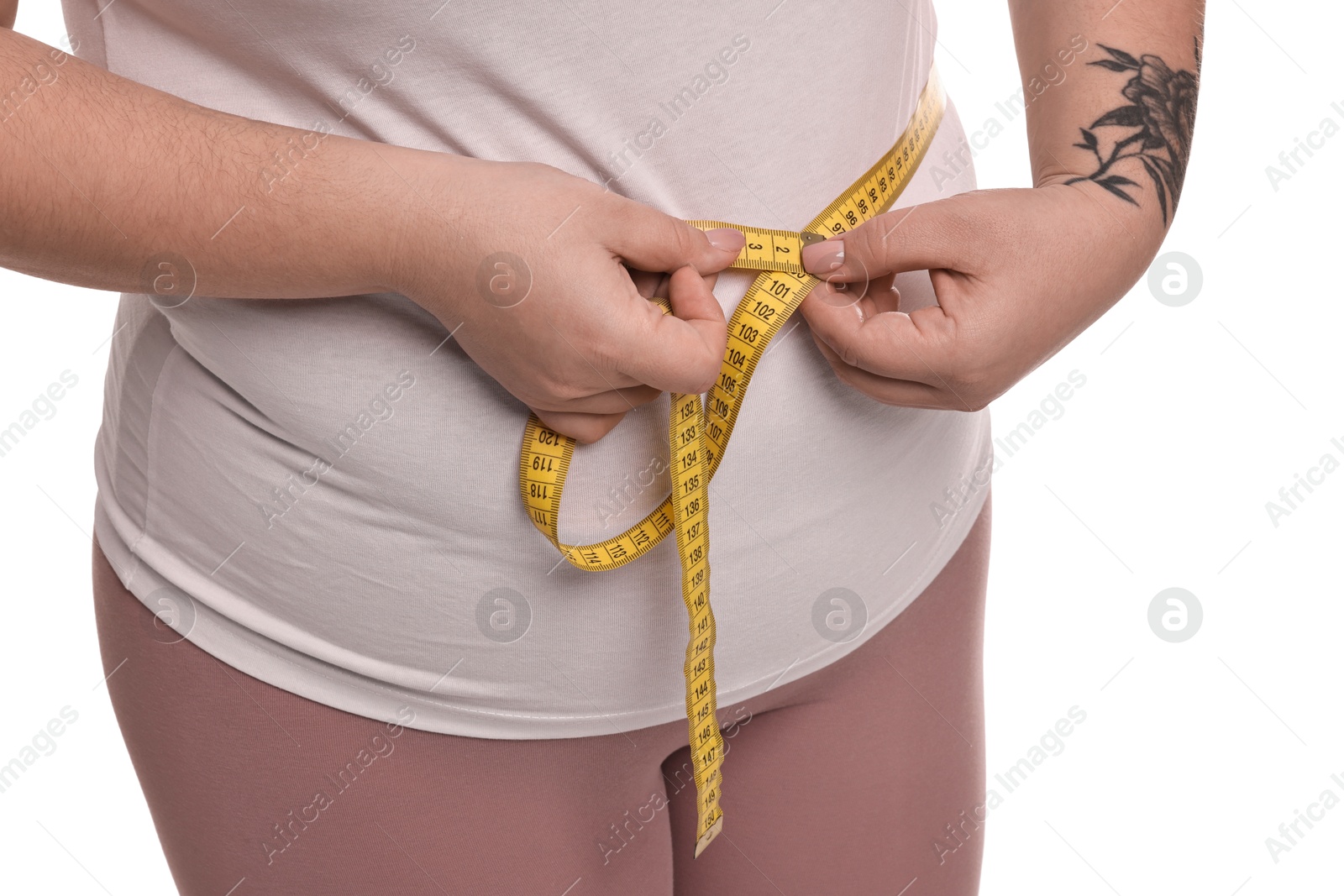 Photo of Weight loss. Plus size woman measuring waist with tape on white background, closeup