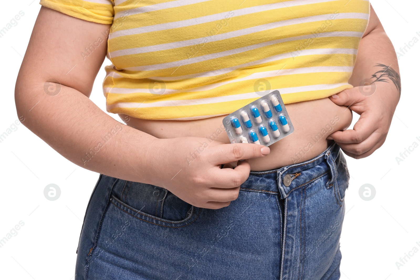 Photo of Plus size woman with blister of weight loss supplements on white background, closeup