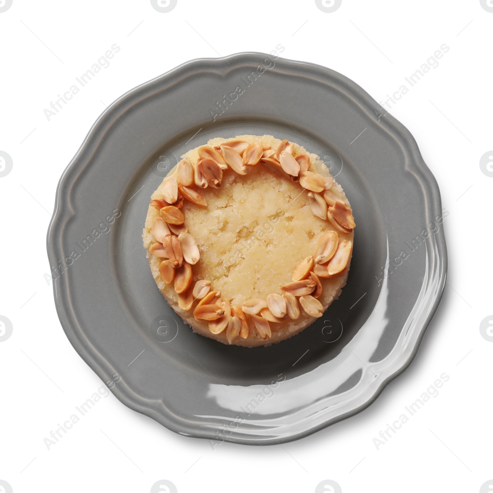 Photo of Delicious semolina halva with almond flakes isolated on white, top view