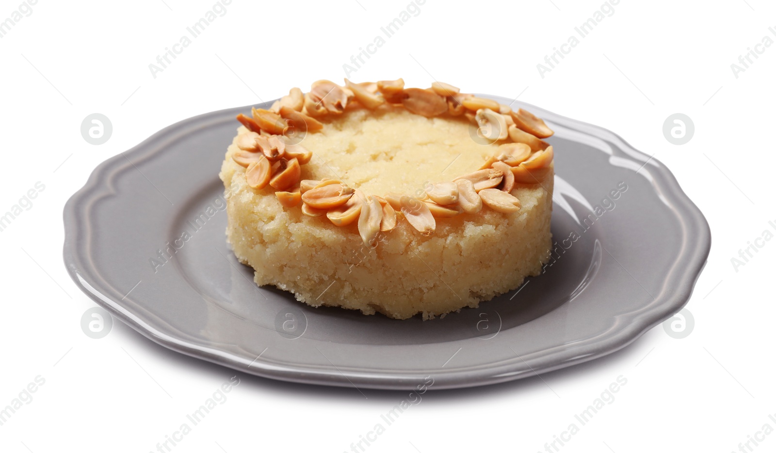 Photo of Delicious semolina halva with almond flakes isolated on white