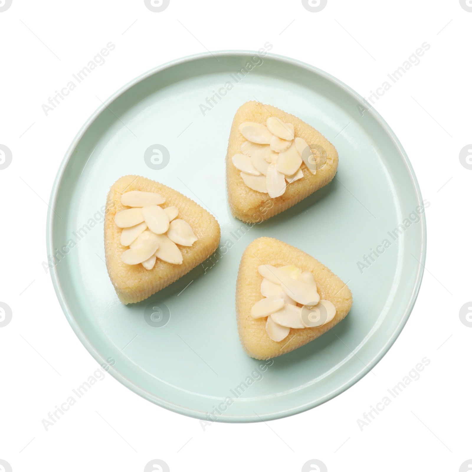 Photo of Pieces of delicious semolina halva with almond flakes isolated on white, top view