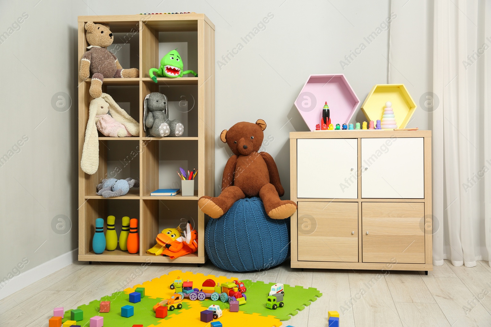 Photo of Beautiful kid's room interior with toys and stylish furniture