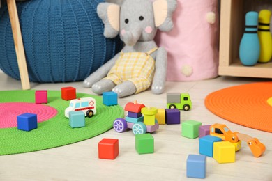 Photo of Colorful cubes and other toys in kid's room