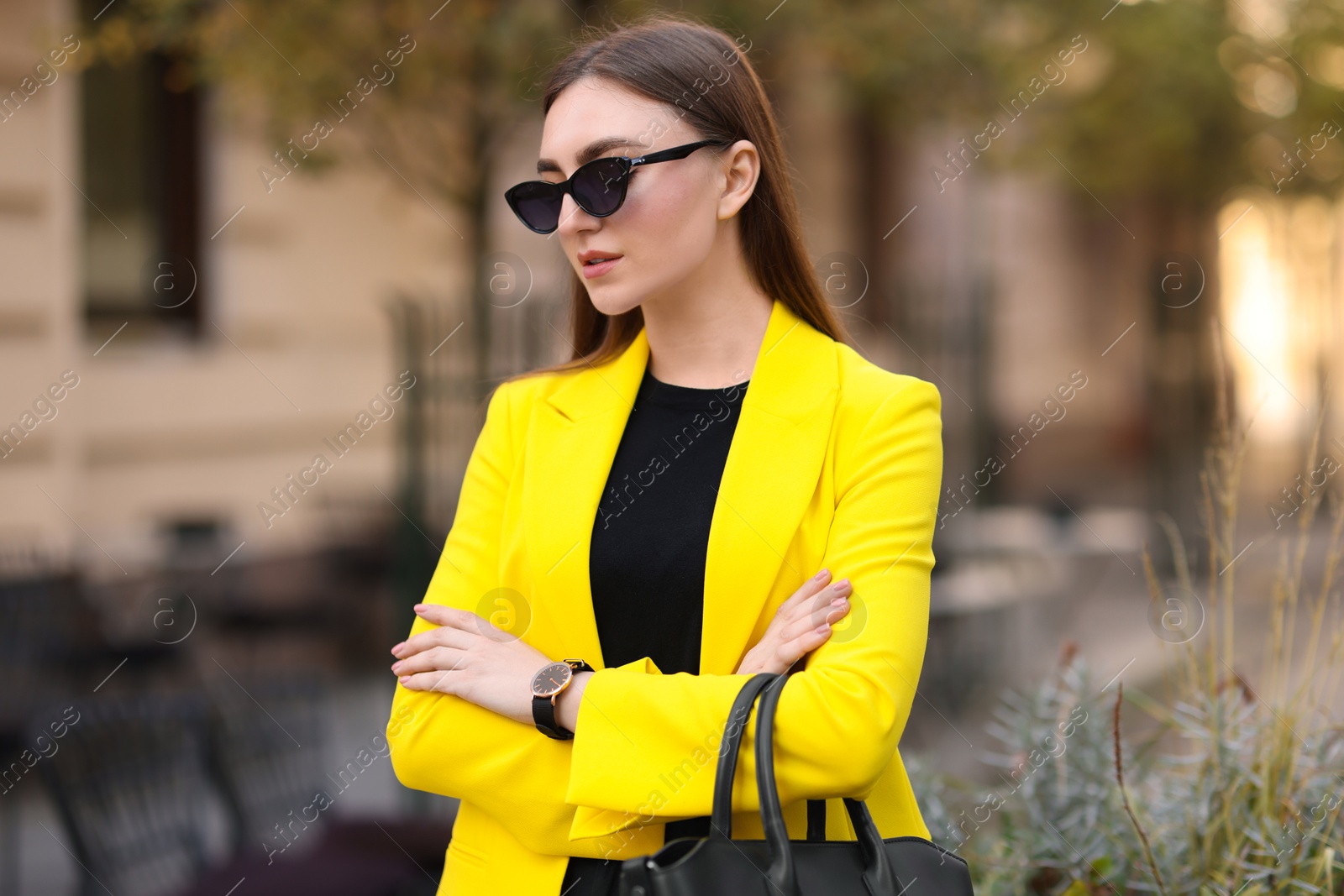 Photo of Beautiful businesswoman in stylish suit on city street