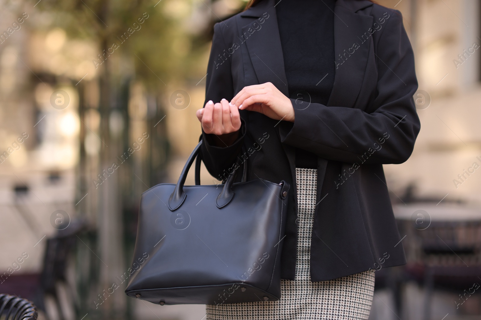 Photo of Businesswoman in stylish suit outdoors, closeup. Space for text