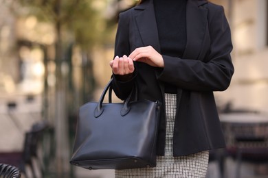 Photo of Businesswoman in stylish suit outdoors, closeup. Space for text