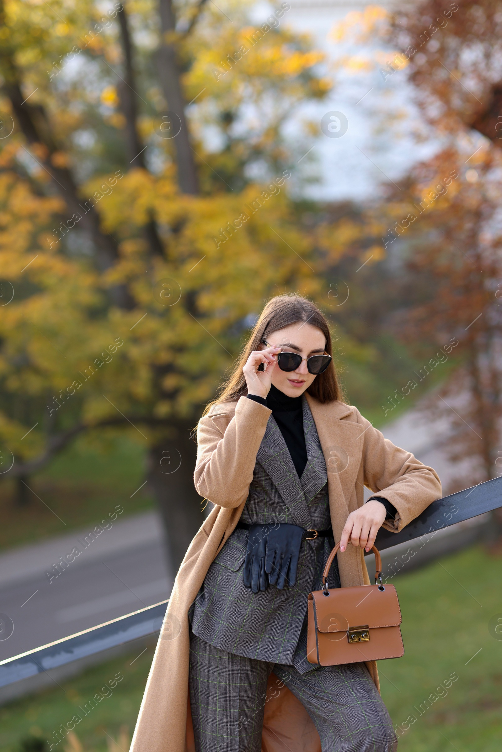 Photo of Beautiful woman in stylish suit outdoors. Space for text