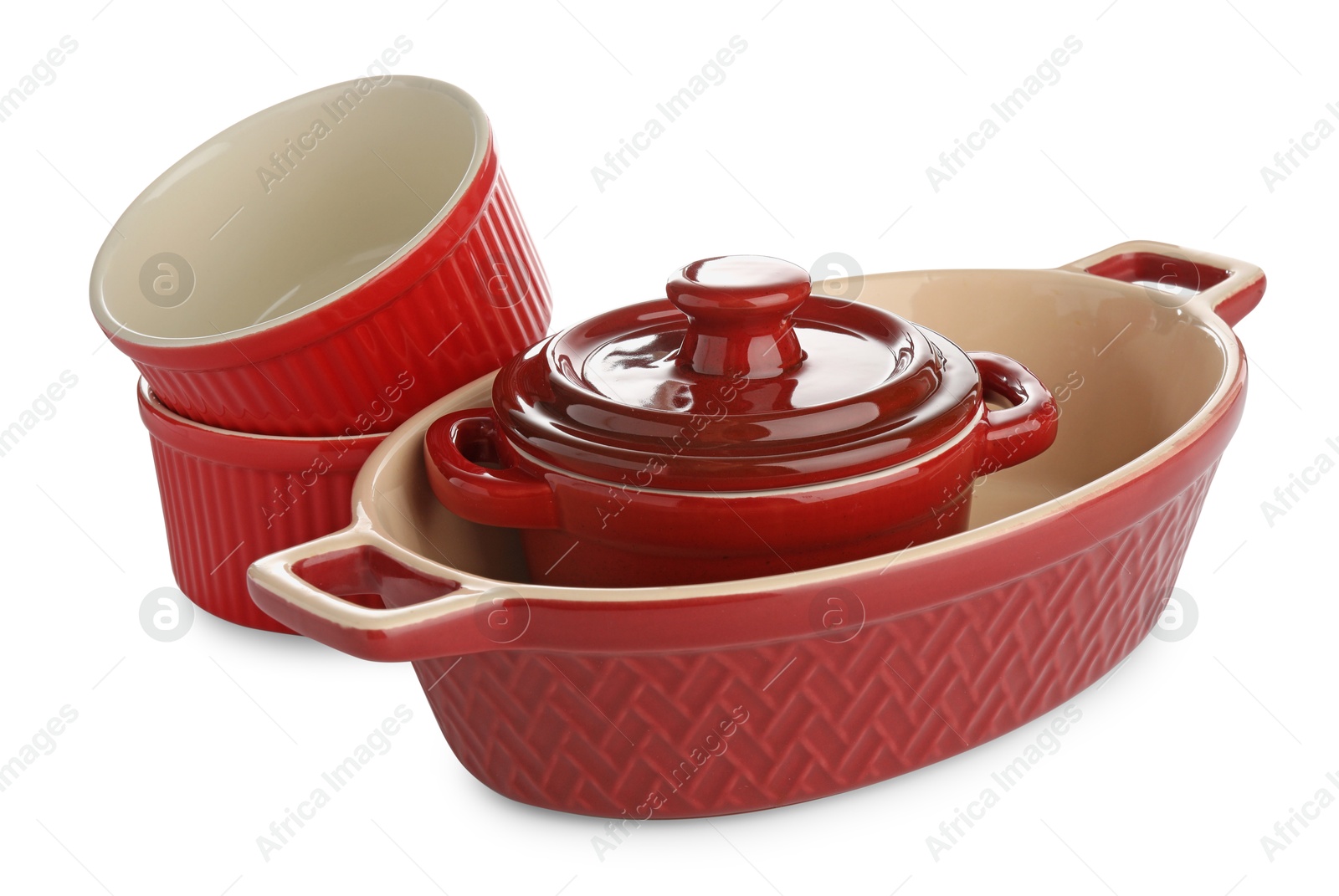 Photo of Different red casseroles isolated on white. Cooking utensil