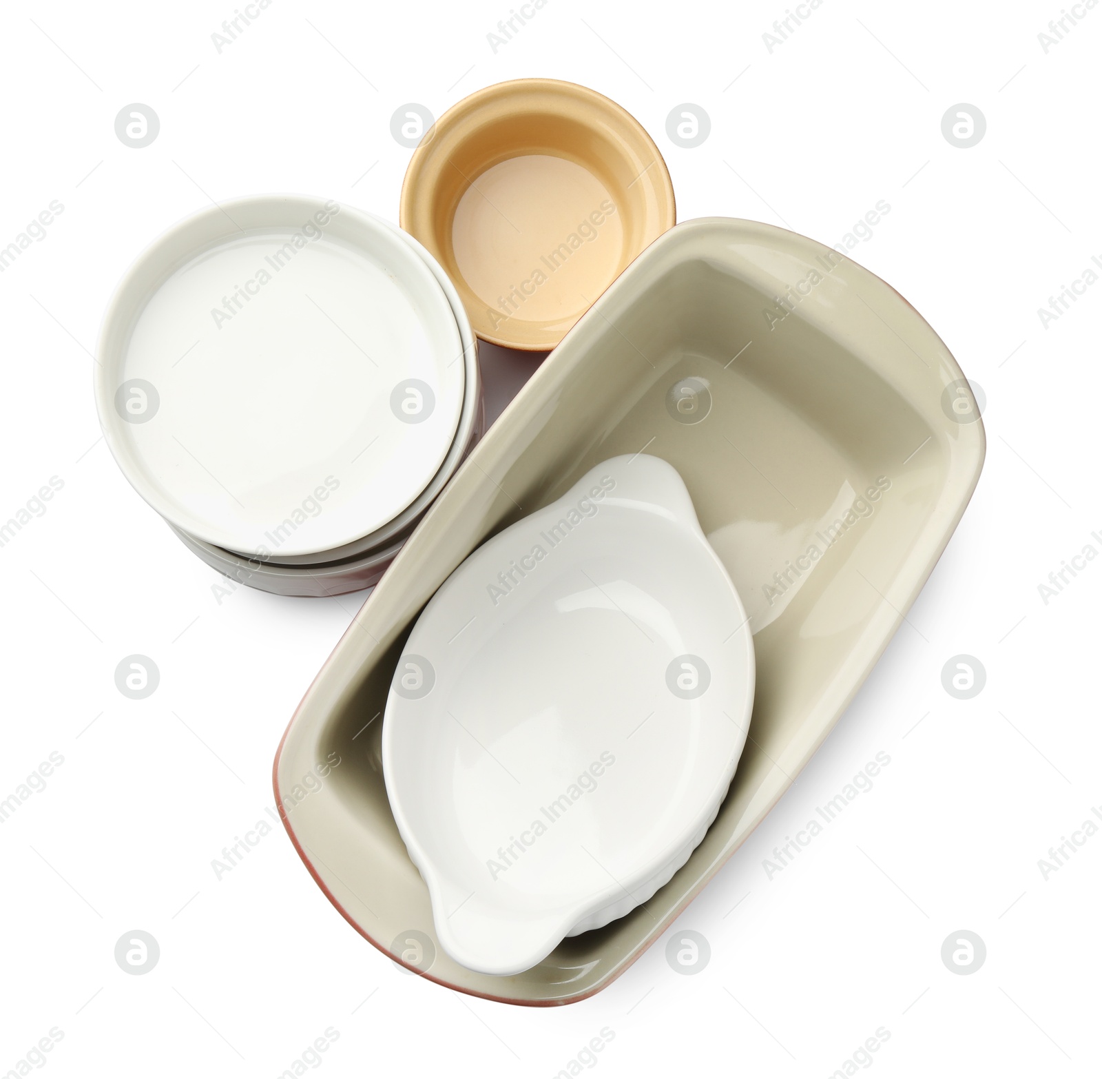 Photo of Different ceramic casseroles isolated on white, top view. Cooking utensil