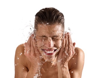 Smiling man washing his face on white background