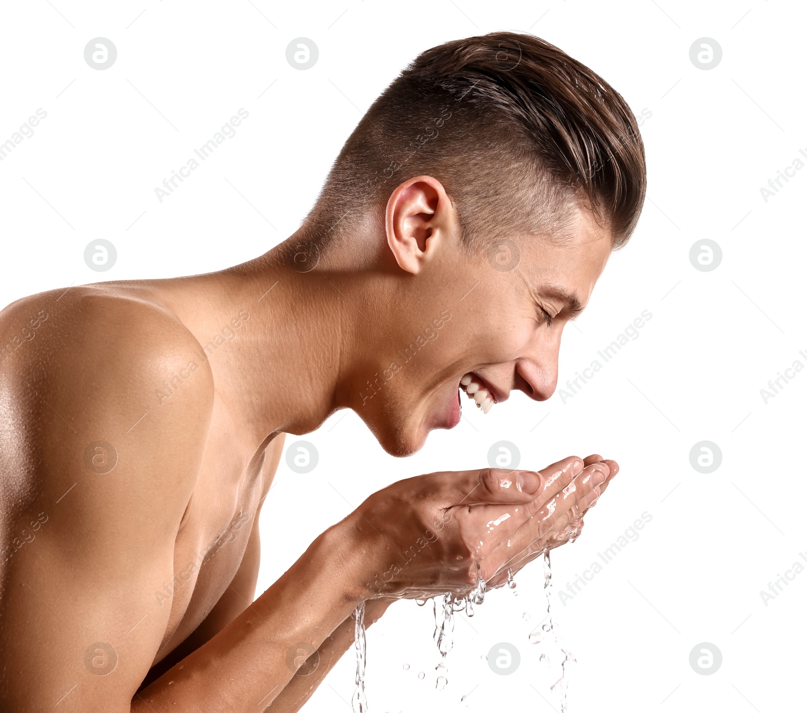 Photo of Happy man washing his face on white background