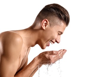 Happy man washing his face on white background