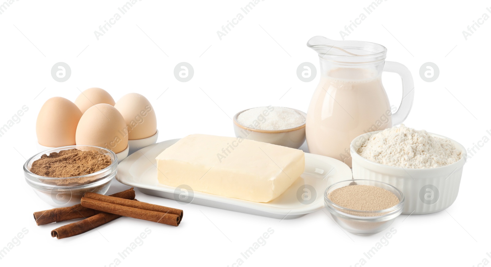 Photo of Making cinnamon rolls. Different ingredients for dough isolated on white