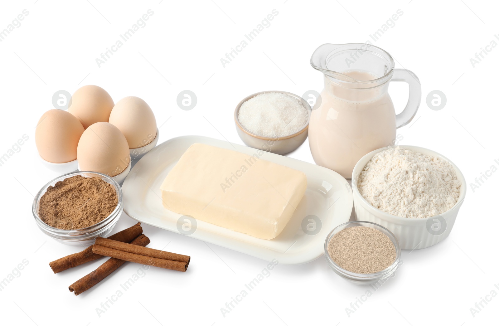 Photo of Making cinnamon rolls. Different ingredients for dough isolated on white