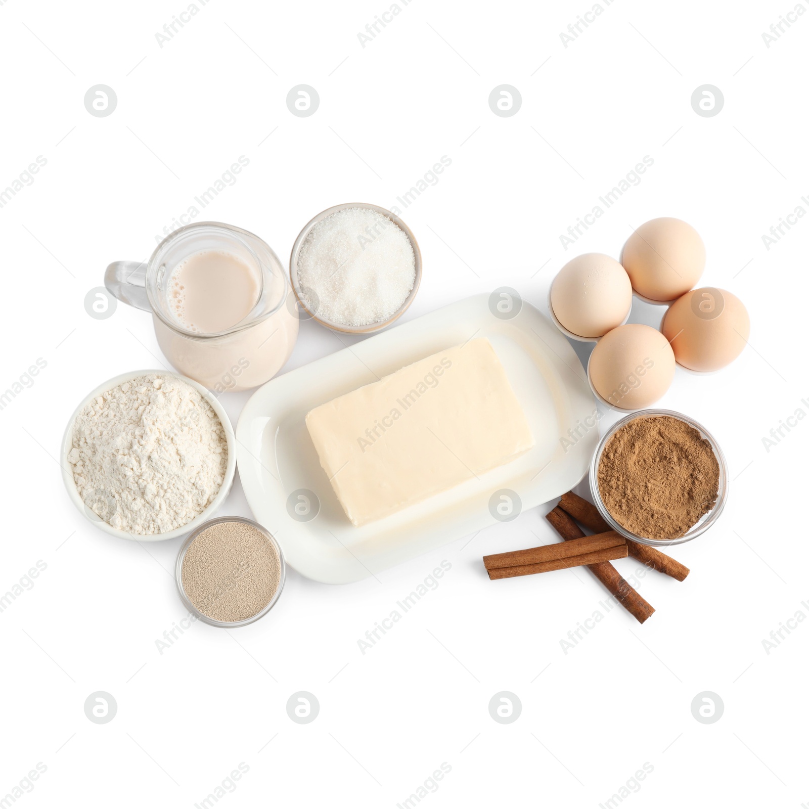 Photo of Making cinnamon rolls. Different ingredients for dough isolated on white, top view